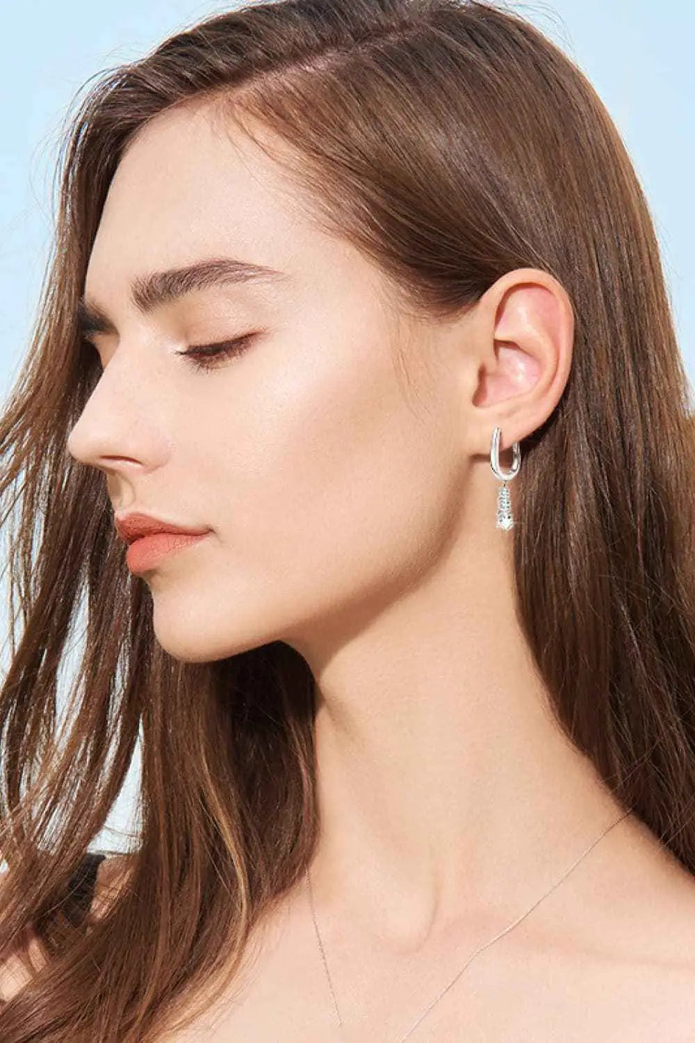 1.8 Carat Moissanite sterling silver drop earrings with minimalist design and clear sparkling stones on a woman