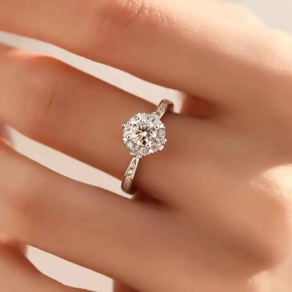1 Carat Moissanite ring in 925 sterling silver with a clear round center stone surrounded by smaller stones on an adjustable band