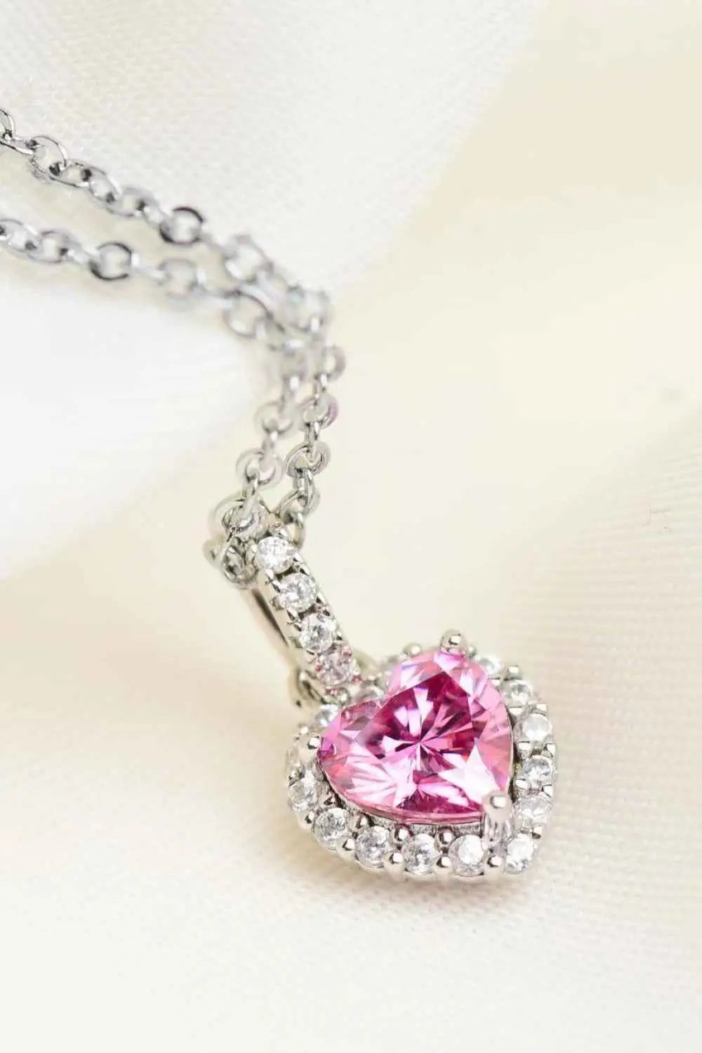 1 Carat Moissanite heart pendant necklace with a pink moissanite center surrounded by clear zircon stones on a silver chain