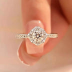 1 Carat Moissanite sterling silver ring with a round center stone surrounded by smaller stones on a detailed band