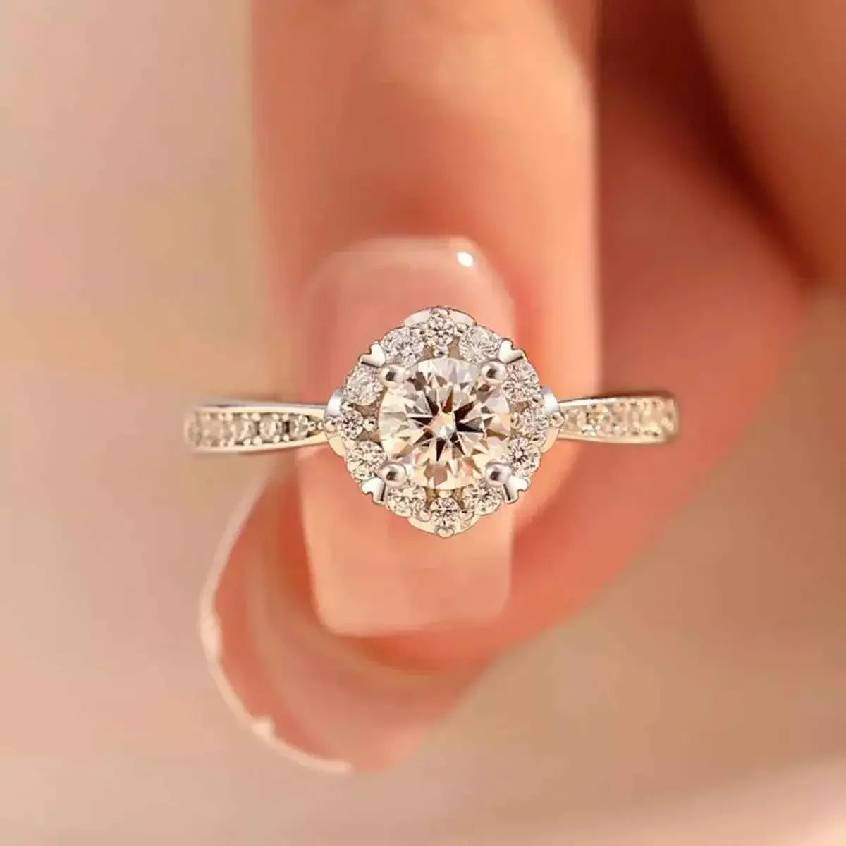 1 Carat Moissanite sterling silver ring with a round center stone surrounded by smaller stones on a detailed band