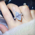 10 Carat Moissanite sterling silver ring with a large marquise-cut clear stone and smaller accent stones on the band
