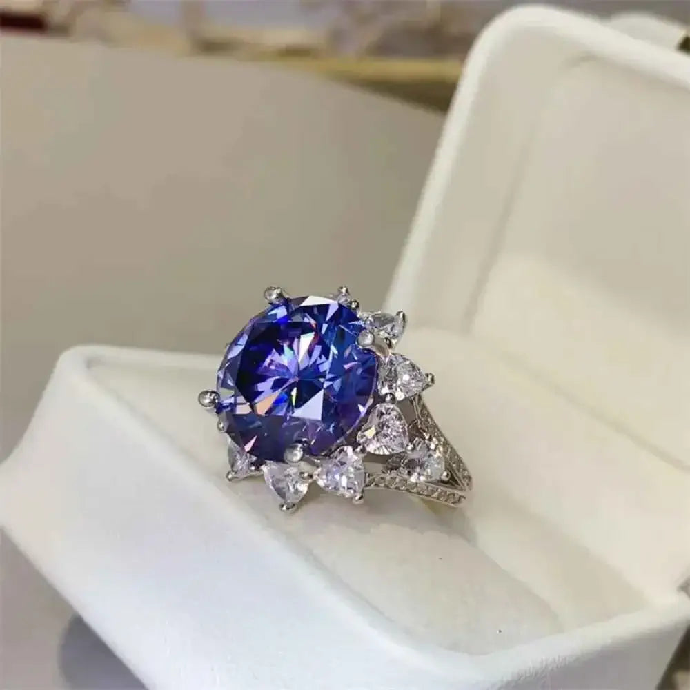 Sterling silver ring featuring a large round 10 Carat Moissanite center stone surrounded by pear-shaped clear stones