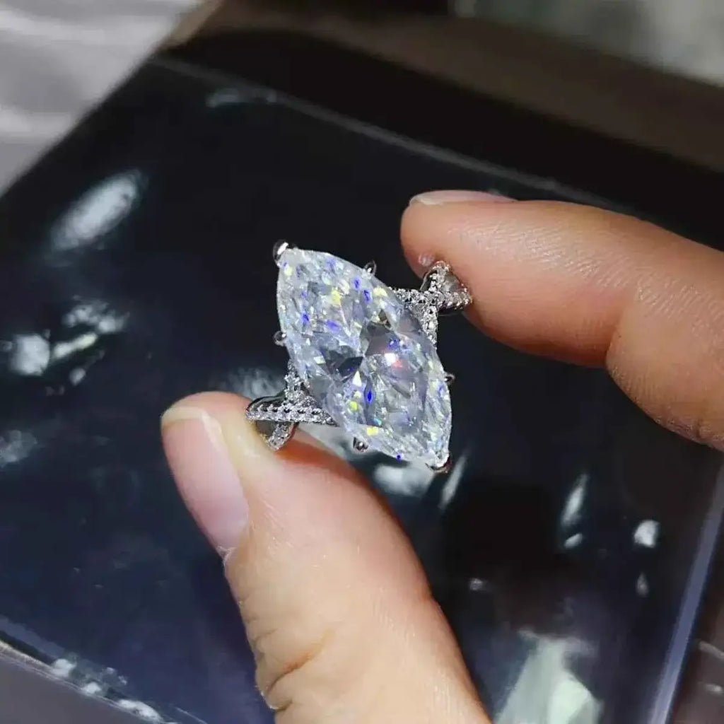 10 Carat Moissanite sterling silver ring featuring a large marquise-cut center stone with a delicate band adorned with small stones