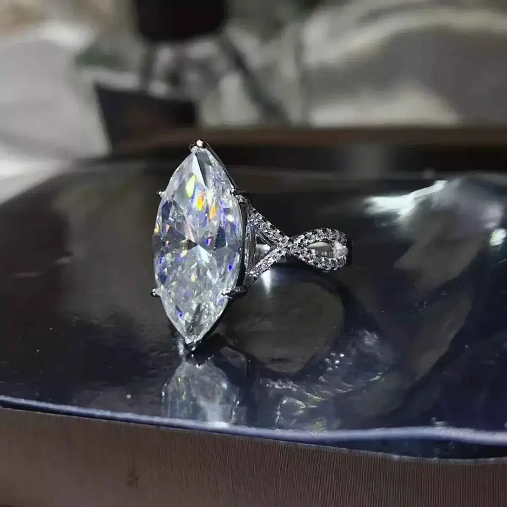 10 Carat Moissanite sterling silver ring with a marquise-cut center stone and a twisted band encrusted with smaller stones