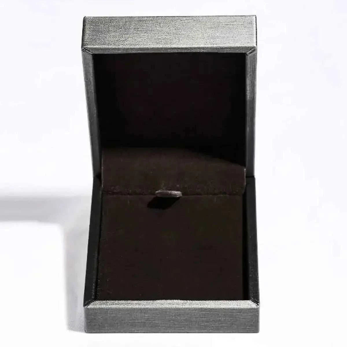 Open silver-tone jewelry box with black velvet interior, empty and standing upright with lid open