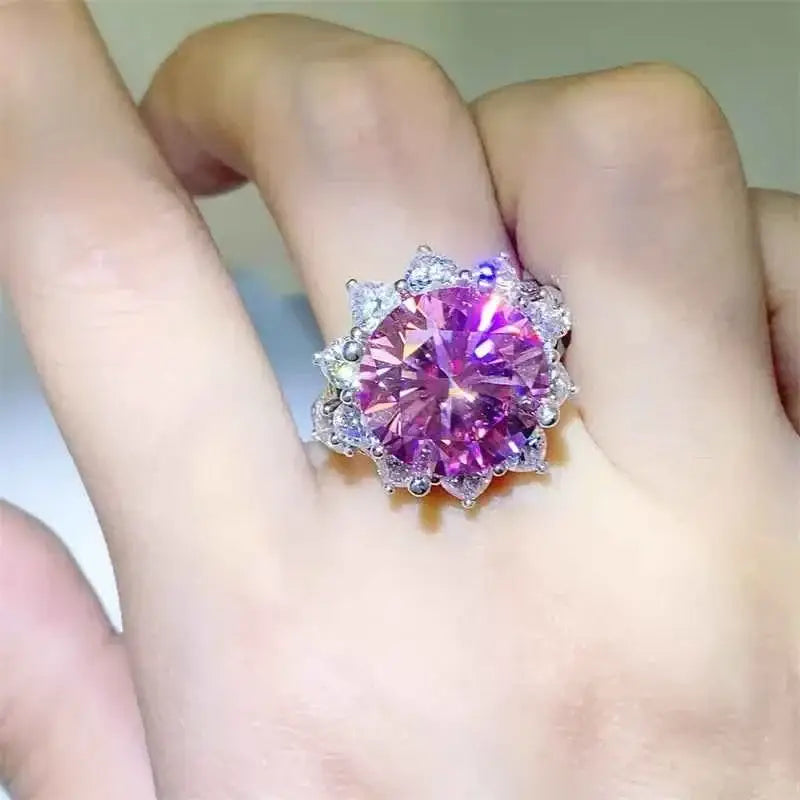 925 sterling silver ring featuring a large pink 10 Carat Moissanite center stone surrounded by clear zircon accent stones