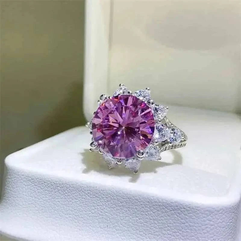Sterling silver ring with a large round purple 10 Carat Moissanite center stone surrounded by small clear zircon accents