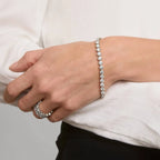 10 CTW moissanite bracelet in white gold plated bezel setting with round brilliant stones worn on wrist