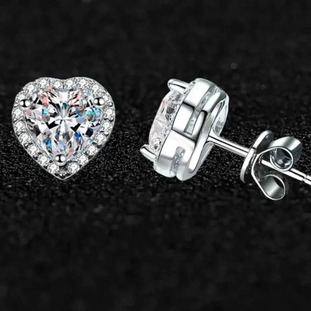 2 Carat heart-shaped 925 sterling silver earrings with clear moissanite center stones surrounded by smaller stones