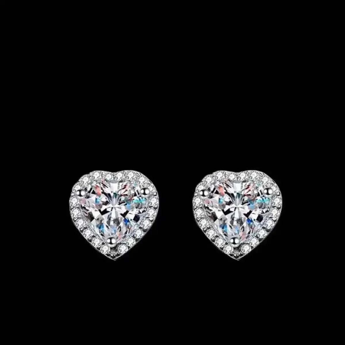 2 Carat heart-shaped sterling silver earrings with sparkling moissanite stones and a halo of smaller clear crystals
