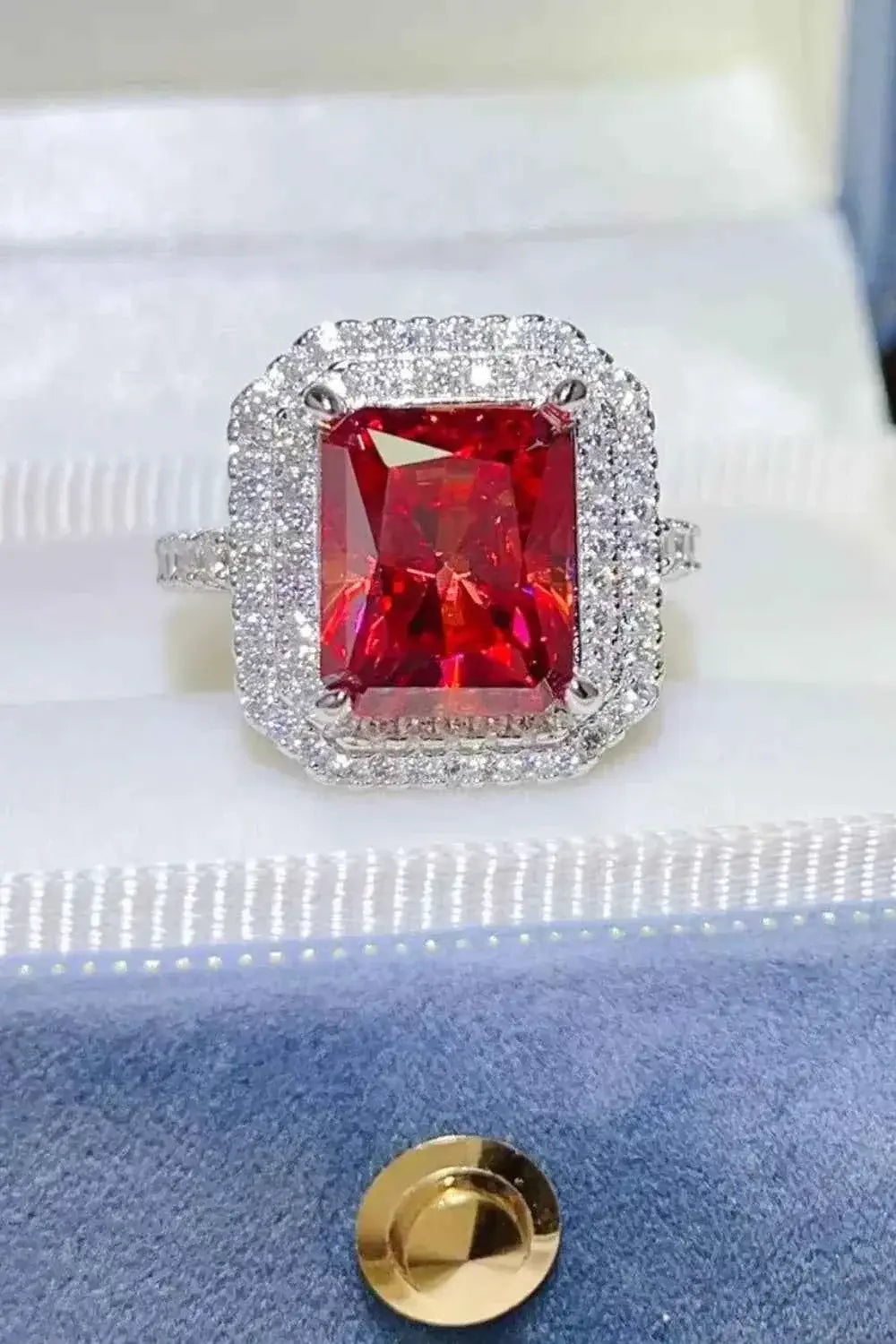 2 Carat Moissanite ring with a large rectangular red gemstone surrounded by smaller clear stones set in silver band