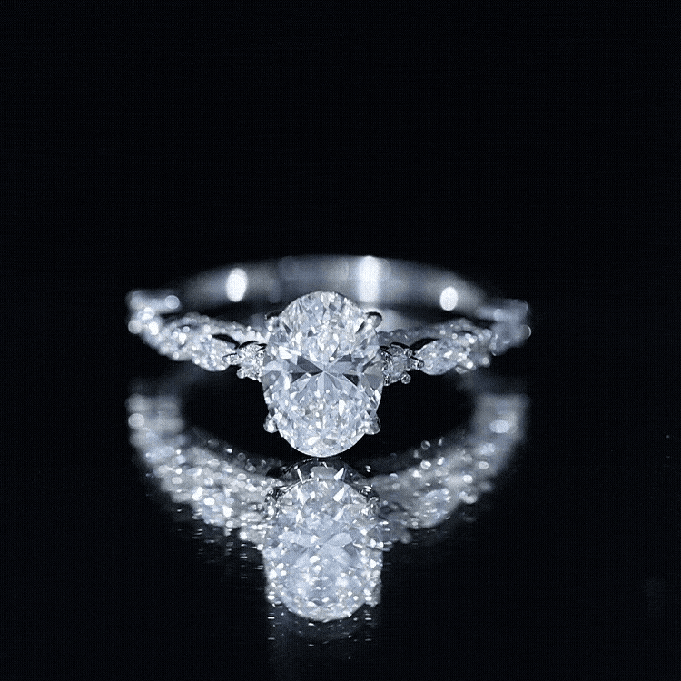 2 Carat Oval Diamond engagement ring with a brilliant oval-cut center stone surrounded by smaller marquise and round diamonds on a polished band