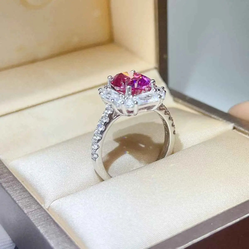 Silver ring with clear and bright pink gemstones set in a rectangular cluster design featuring small stones on the band, showcasing 3 Carat Moissanite.