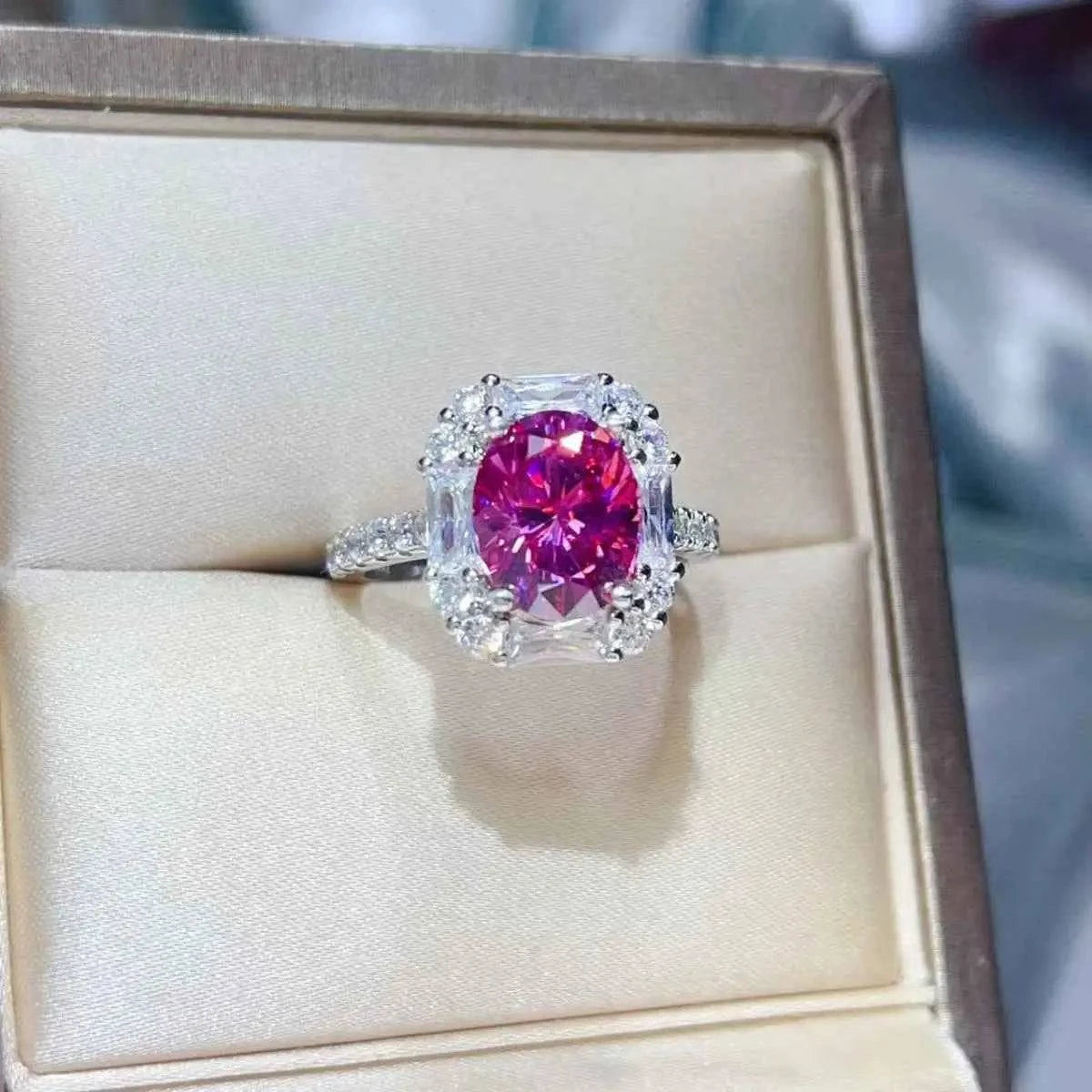 925 sterling silver ring featuring a 3 Carat Moissanite vibrant pink center stone with clear accent stones and a detailed band design