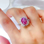 925 sterling silver ring with a large vibrant pink center stone surrounded by clear stones, featuring a 3 Carat Moissanite centerpiece