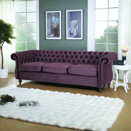 Luxurious purple velvet sofa for timeless designer clothing aesthetics