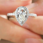 4 Carat 925 sterling silver ring with a teardrop-shaped moissanite center stone surrounded by small accent stones