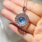 5 Carat sterling silver pendant necklace with intricate filigree design and a central round blue moissanite gemstone