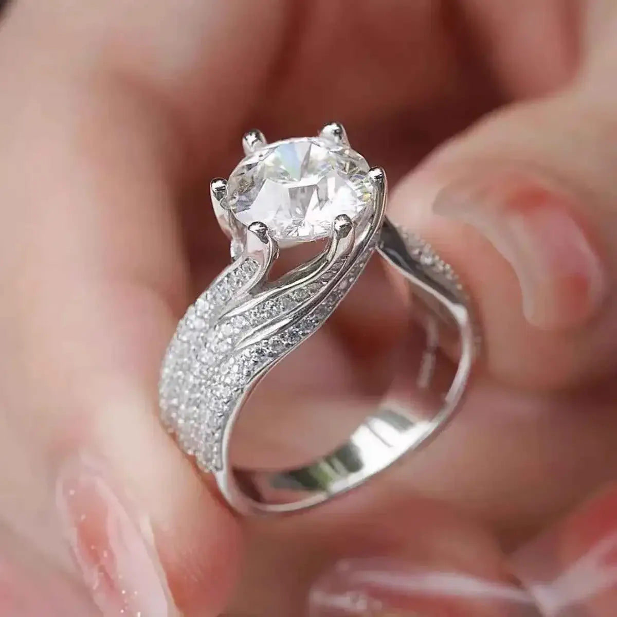 925 sterling silver ring with a large round 5 Carat Moissanite center stone and pavé smaller stones along the band