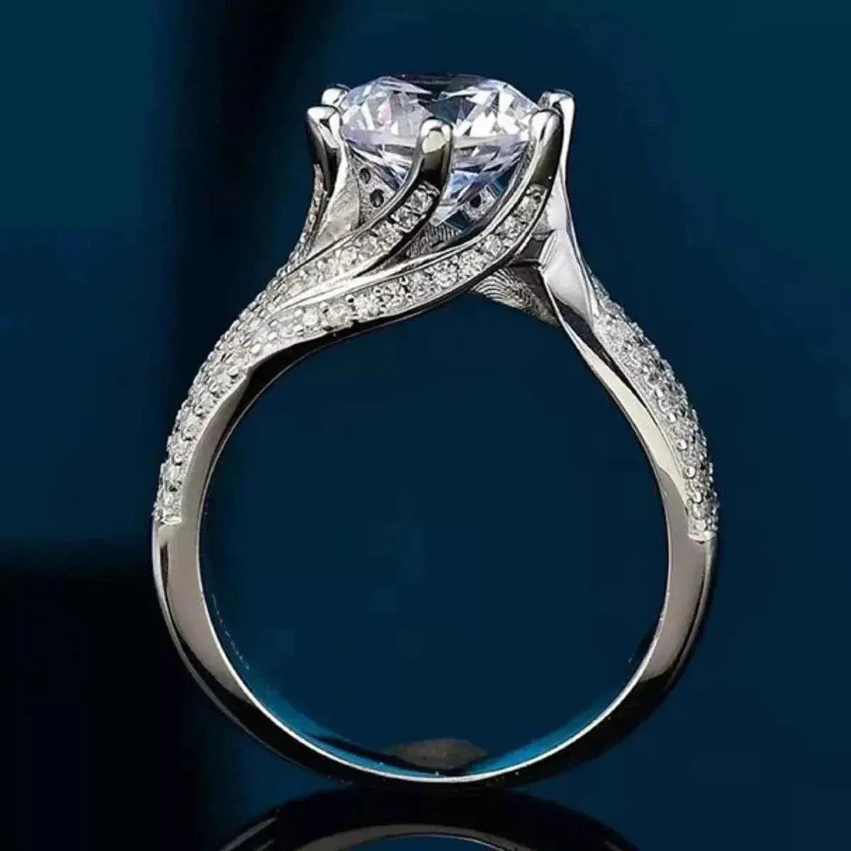 925 sterling silver ring with a large round 5 Carat Moissanite center stone and small accent stones on the band