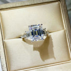 925 sterling silver ring with a large square-cut 5 Carat Moissanite center stone and smaller side stones in a polished setting