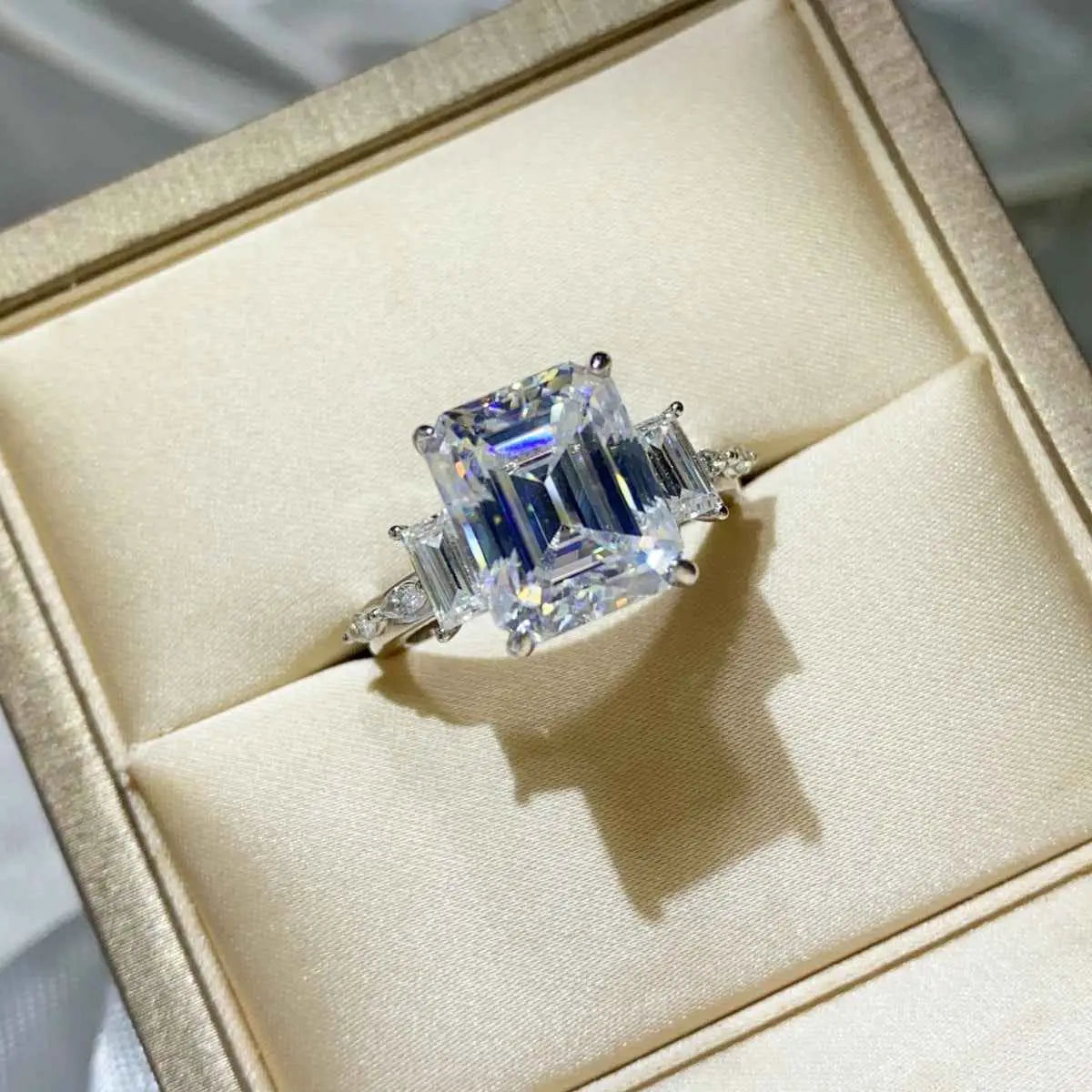 925 sterling silver ring with a large rectangular 5 Carat Moissanite center stone flanked by smaller baguette-cut stones