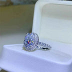 5 Carat Moissanite silver ring with a large oval center stone surrounded by smaller stones on a pavé band