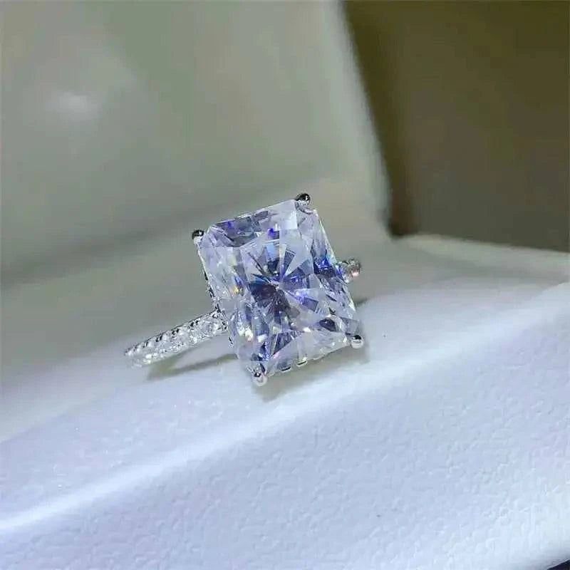 925 sterling silver ring with a large rectangular 5 Carat Moissanite center stone and small accent zircons on the band