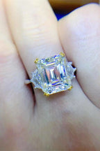 5 Carat Moissanite ring with a large square-cut stone set in a silver band with gold prongs and side accents