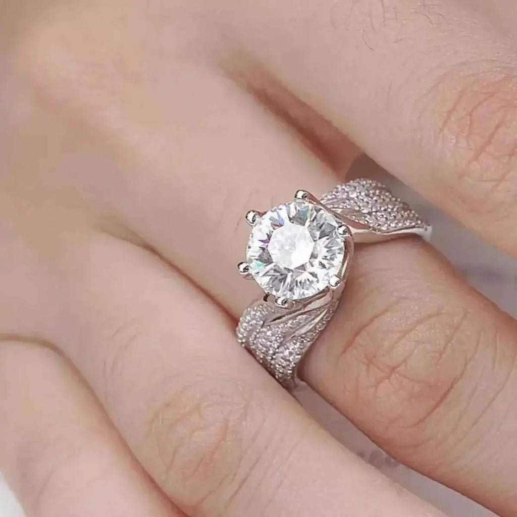925 sterling silver ring with a large round 5 Carat Moissanite center stone and intricate pavé detailing on the band