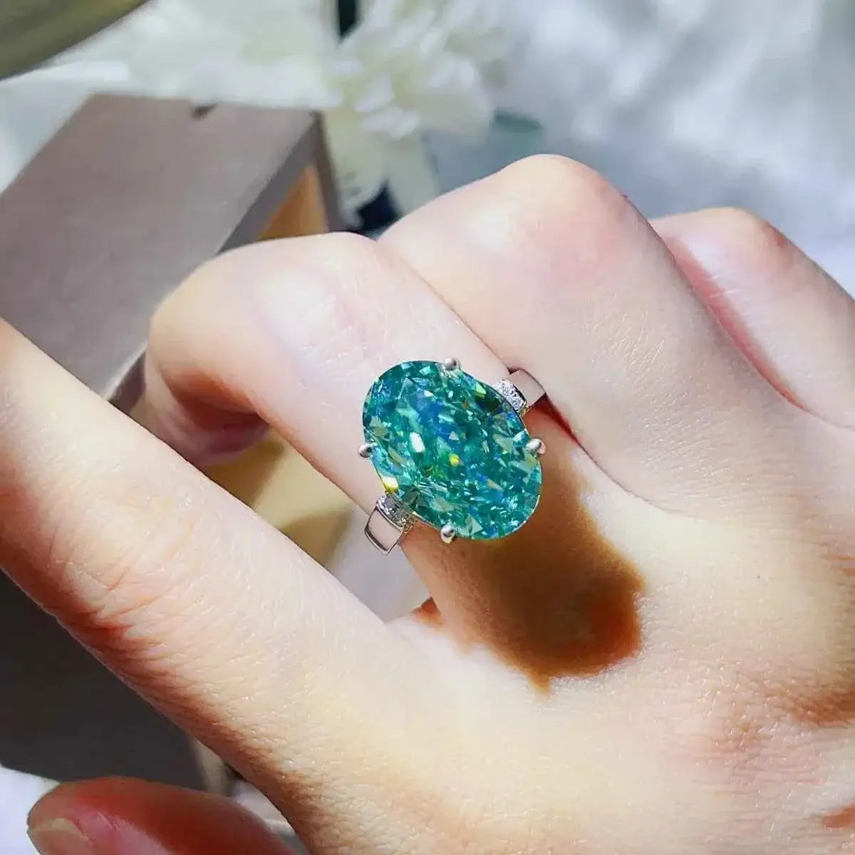 925 sterling silver ring with a large oval blue-green gemstone featuring the 5 Carat Moissanite centerpiece design
