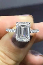 5 Carat Moissanite ring with emerald-cut center stone, sterling silver band, platinum plated with zircon side stones