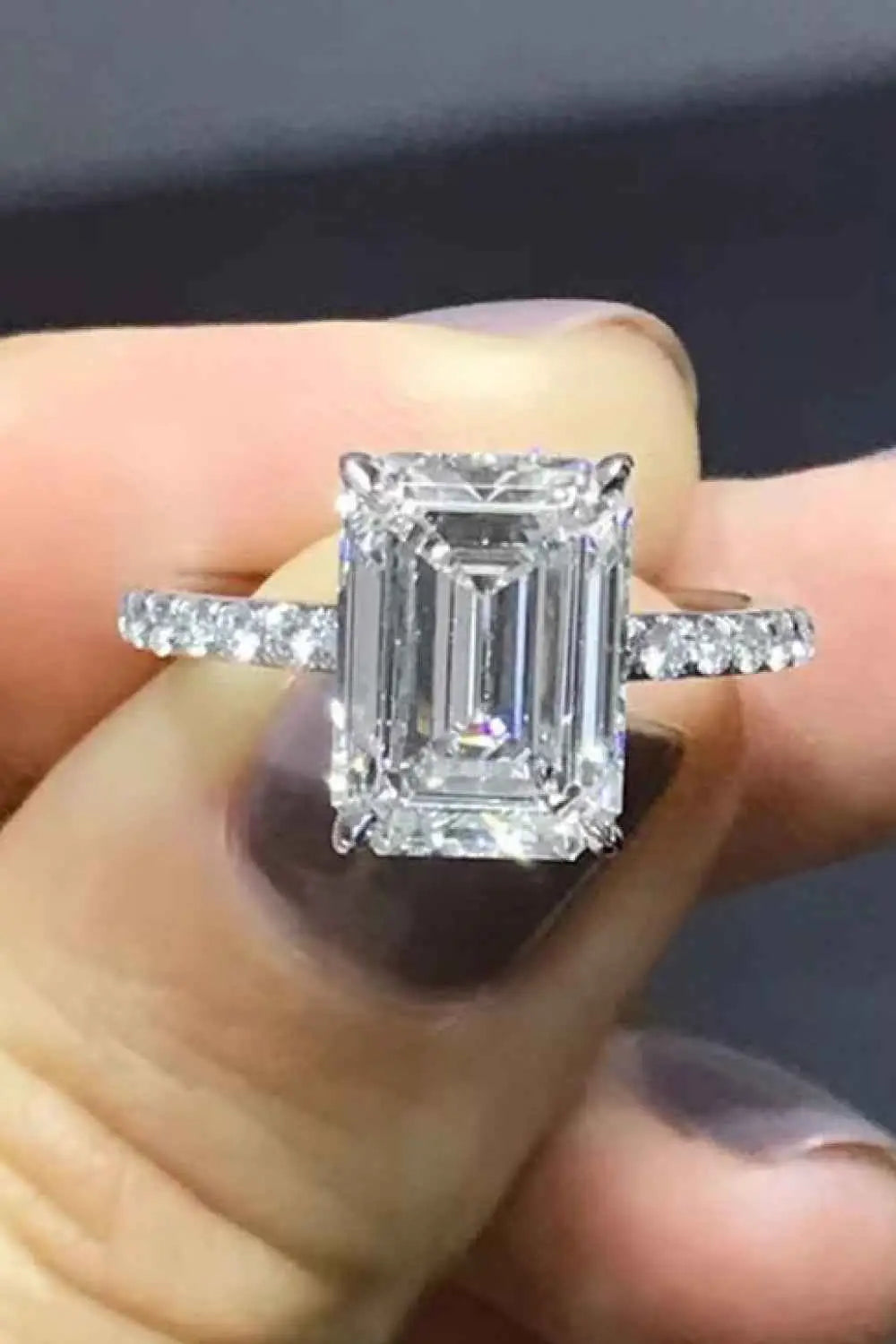 5 Carat Moissanite ring with emerald-cut center stone, sterling silver band, platinum plated with zircon side stones