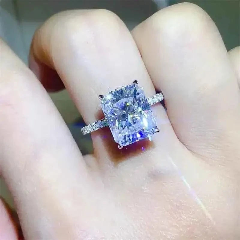 925 sterling silver ring with a large square-cut 5 Carat Moissanite center stone and smaller accent stones on the band