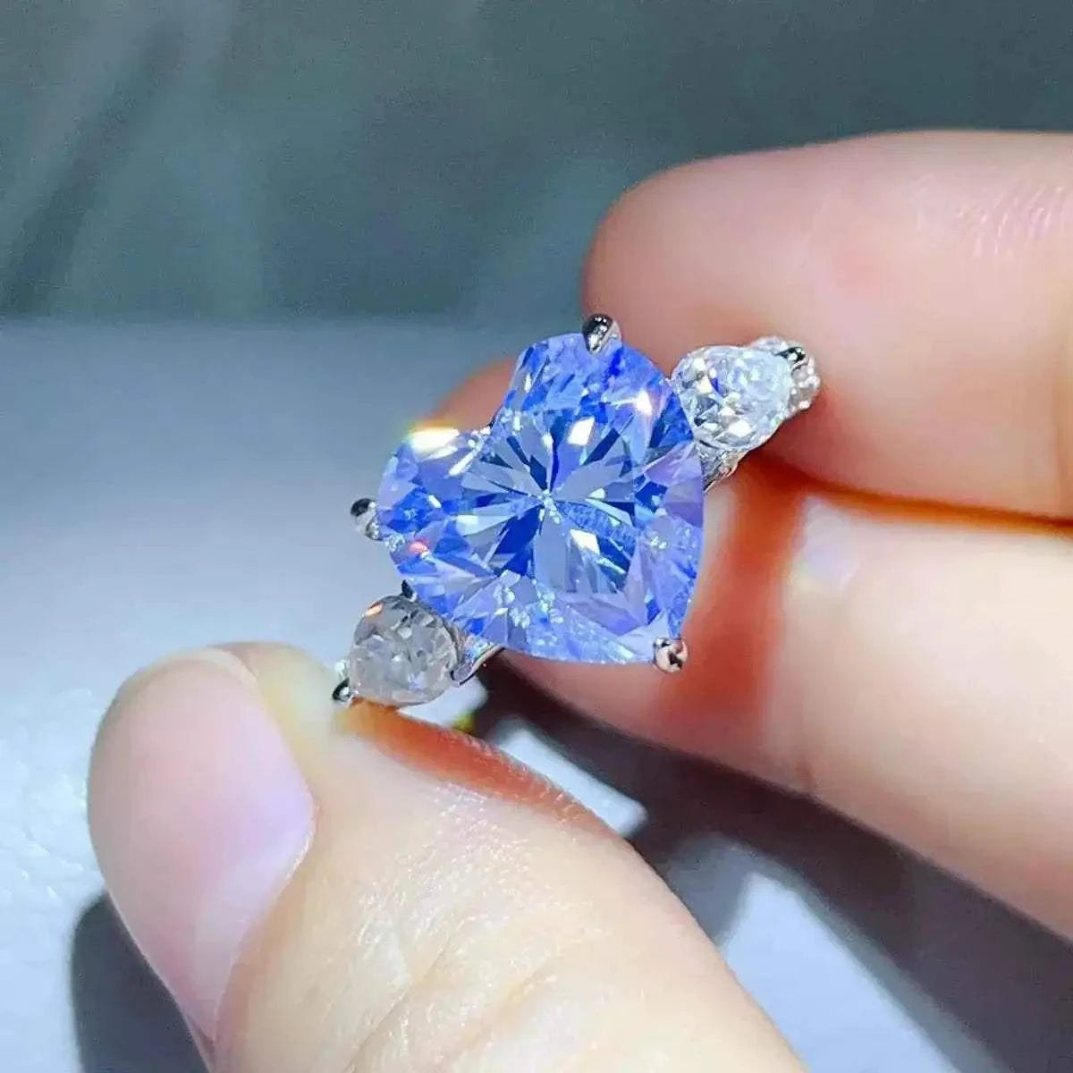 6 Carat heart-shaped blue gemstone ring in 925 sterling silver with two smaller clear stones on sides