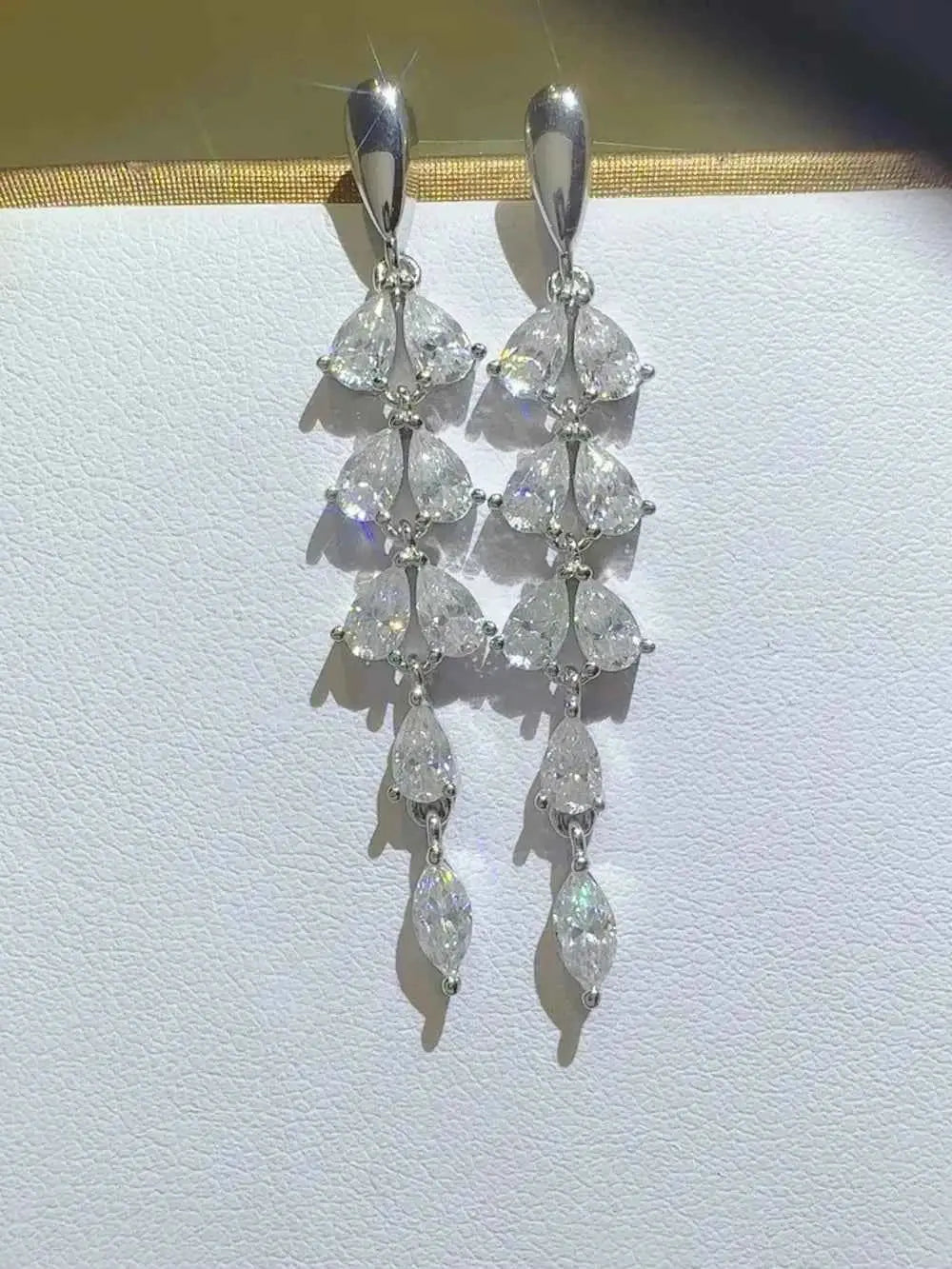 925 sterling silver dangling earrings with pear-shaped stones, showcasing 6 Carat Moissanite in a tiered design