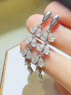 6 Carat Moissanite sterling silver dangle earrings with teardrop shaped clear stones in a cascading design