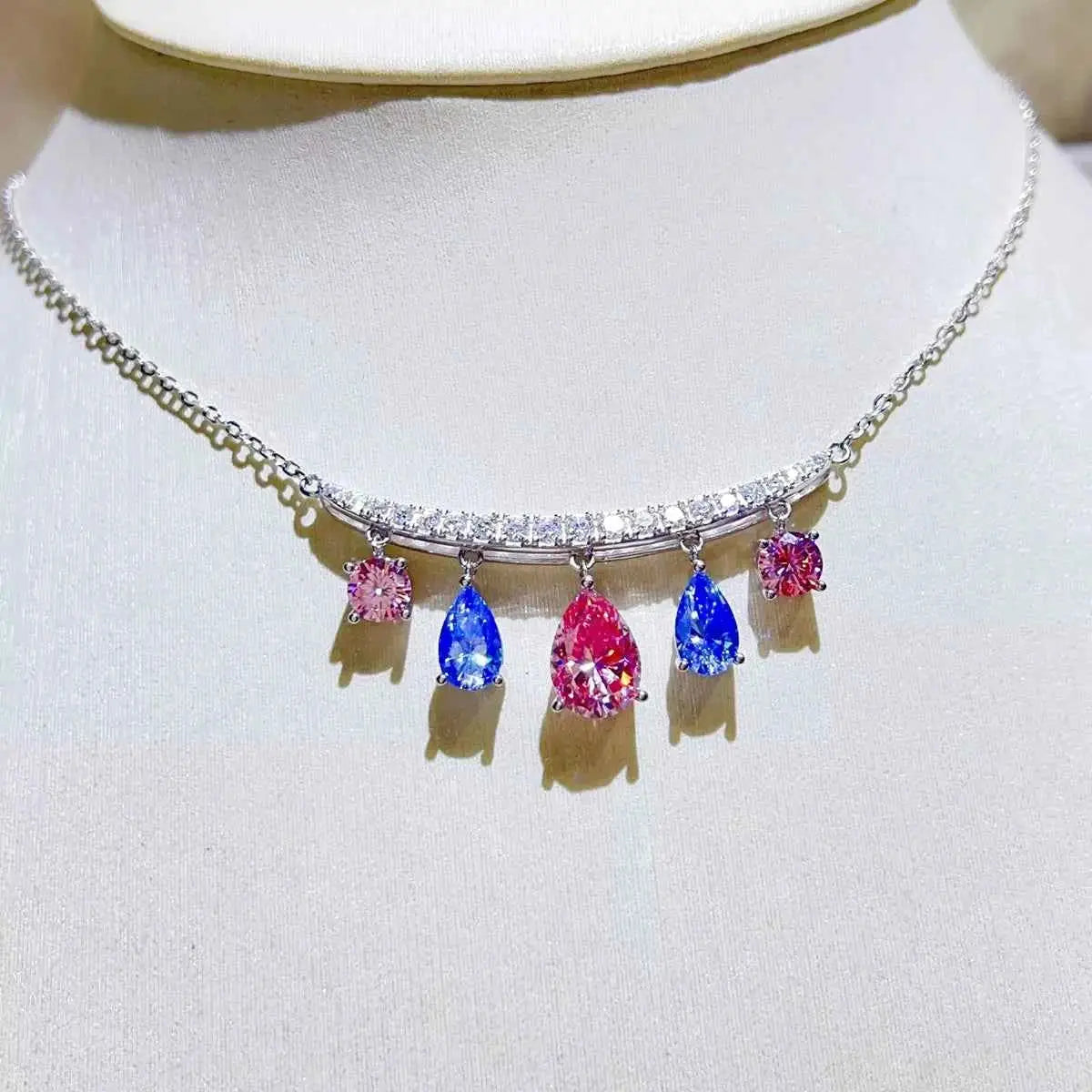 6 Carat necklace with 925 sterling silver chain and bar, featuring pink and blue teardrop and square gemstones in a symmetrical design.