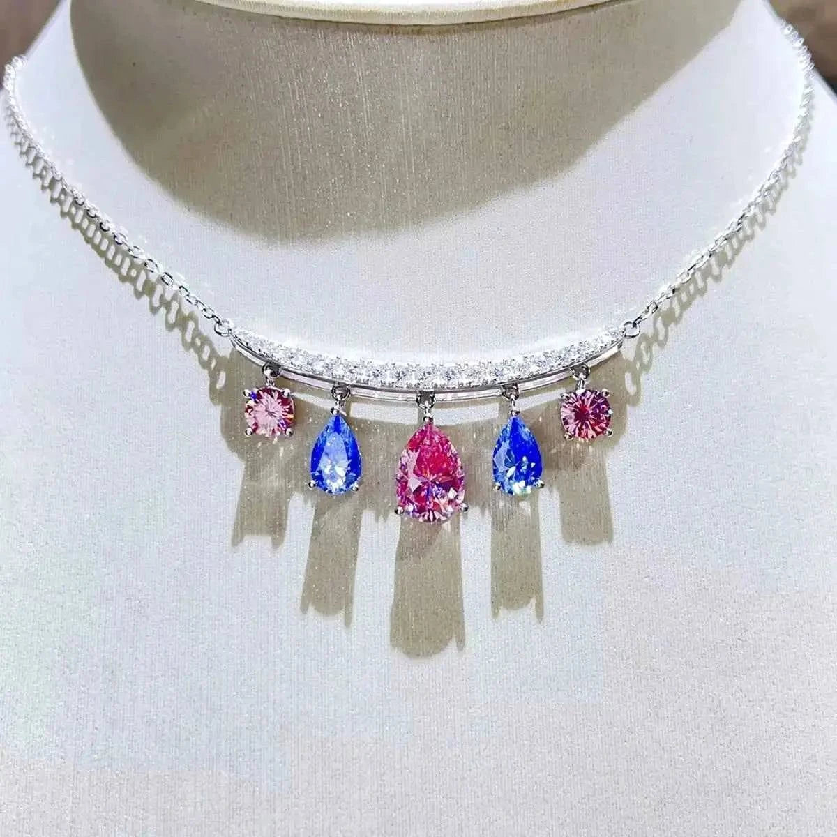 6 Carat necklace featuring a 925 sterling silver chain with teardrop-shaped pink and blue gemstones and round pink stones