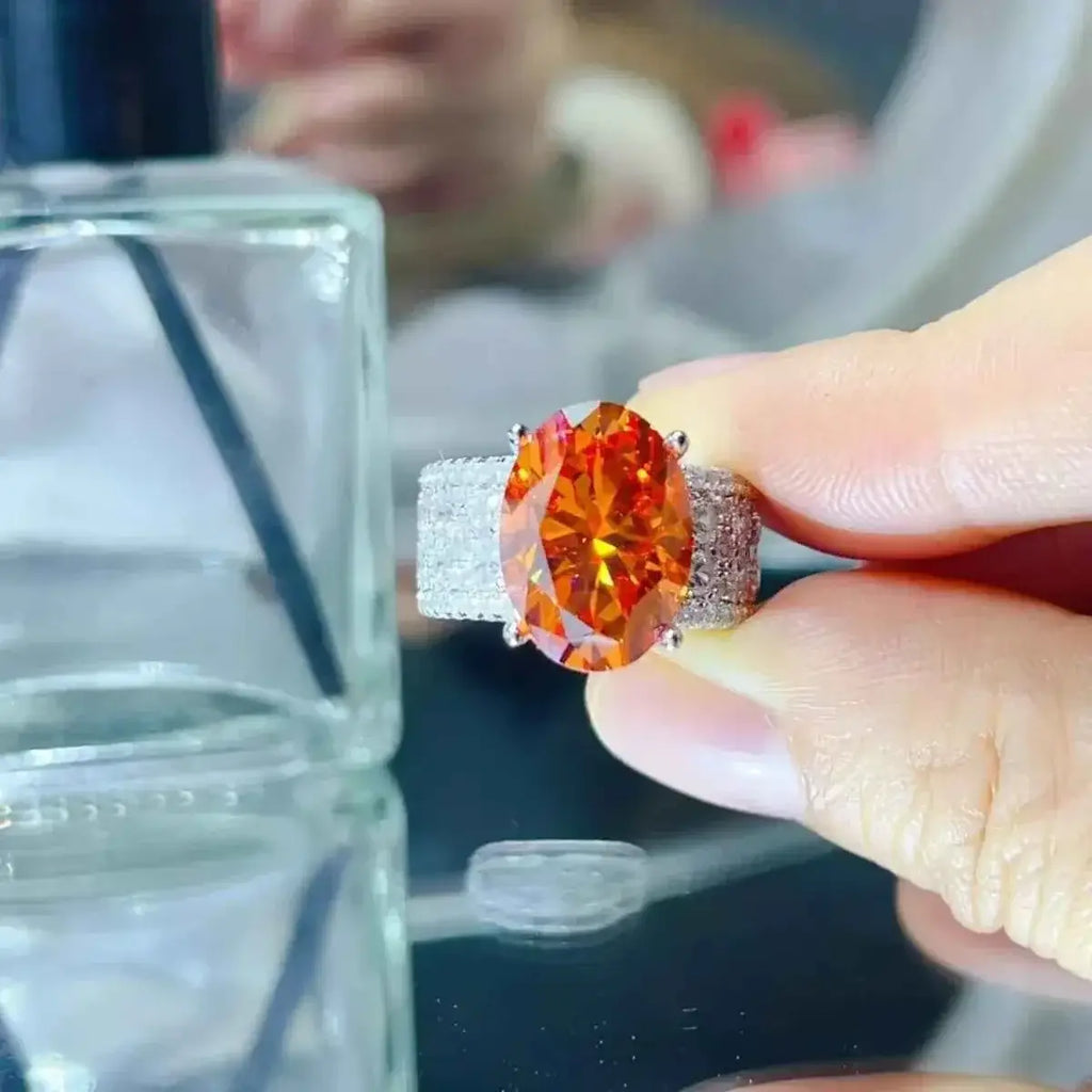 925 sterling silver ring with an oval orange 8 Carat Moissanite center stone and pavé-set band detailing