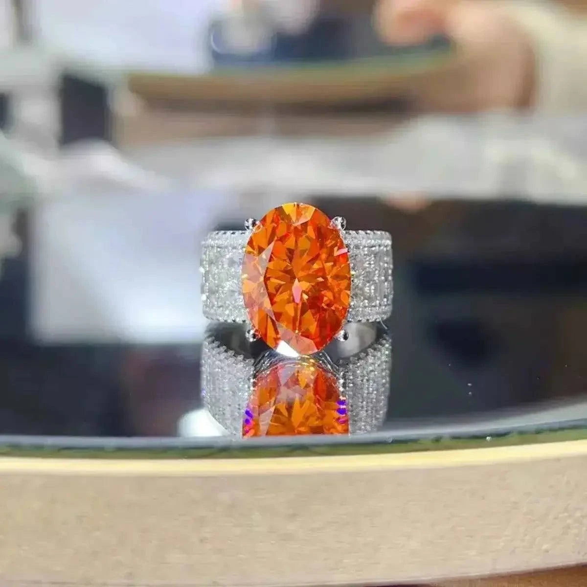 925 sterling silver ring with an oval vibrant orange center stone and sparkling band featuring the 8 Carat Moissanite centerpiece