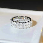 925 Sterling Silver Moissanite Ring featuring a triple row of clear, sparkling round-cut stones set in polished silver band