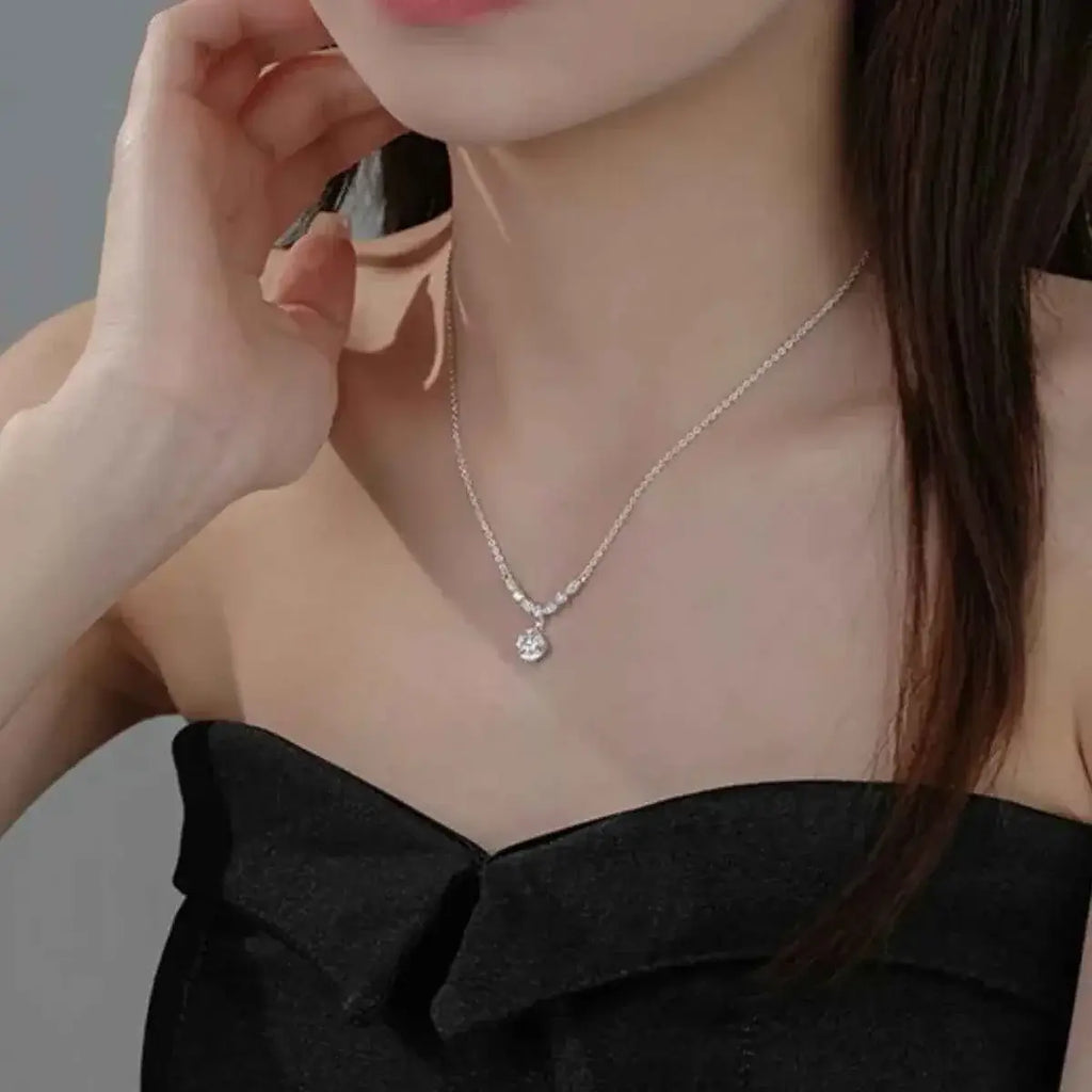 925 Sterling Silver pendant necklace with a delicate chain and a small clear zircon charm worn on a female model