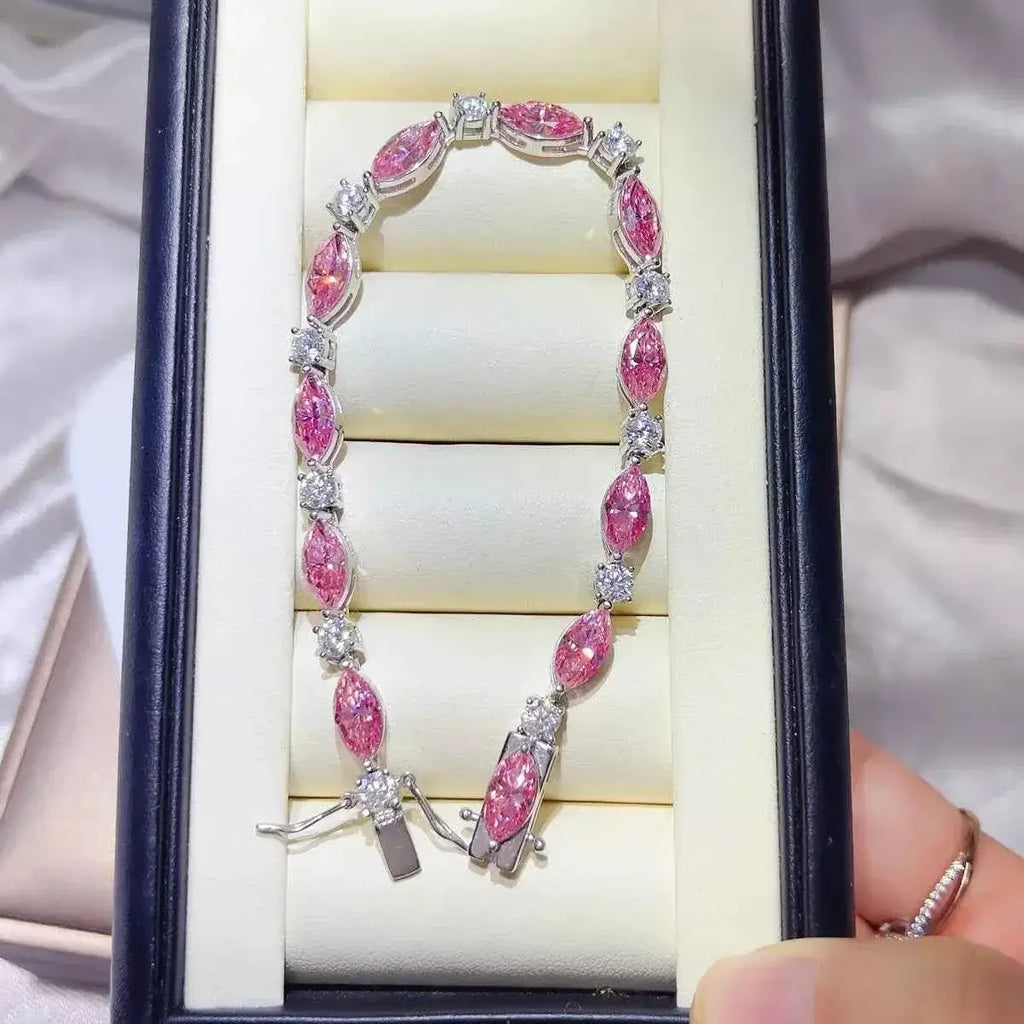 925 Sterling Silver bracelet featuring alternating pink marquise and clear round moissanite stones set in silver links, displayed in a white cushioned box