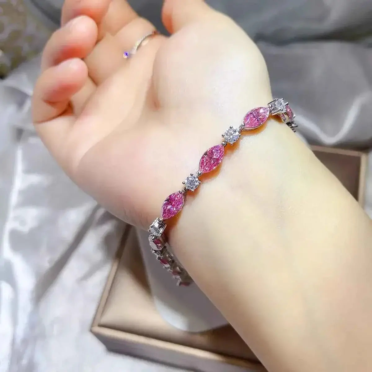 925 Sterling Silver bracelet featuring alternating pink marquise and clear round stones on a delicate chain worn on wrist