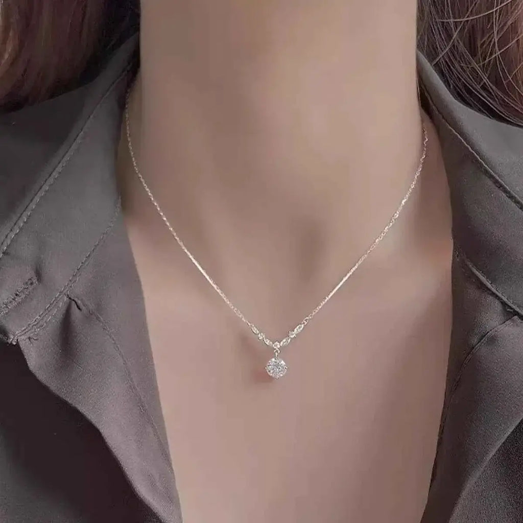 925 Sterling Silver delicate necklace with a small round zircon pendant on a fine chain worn on a woman's neck