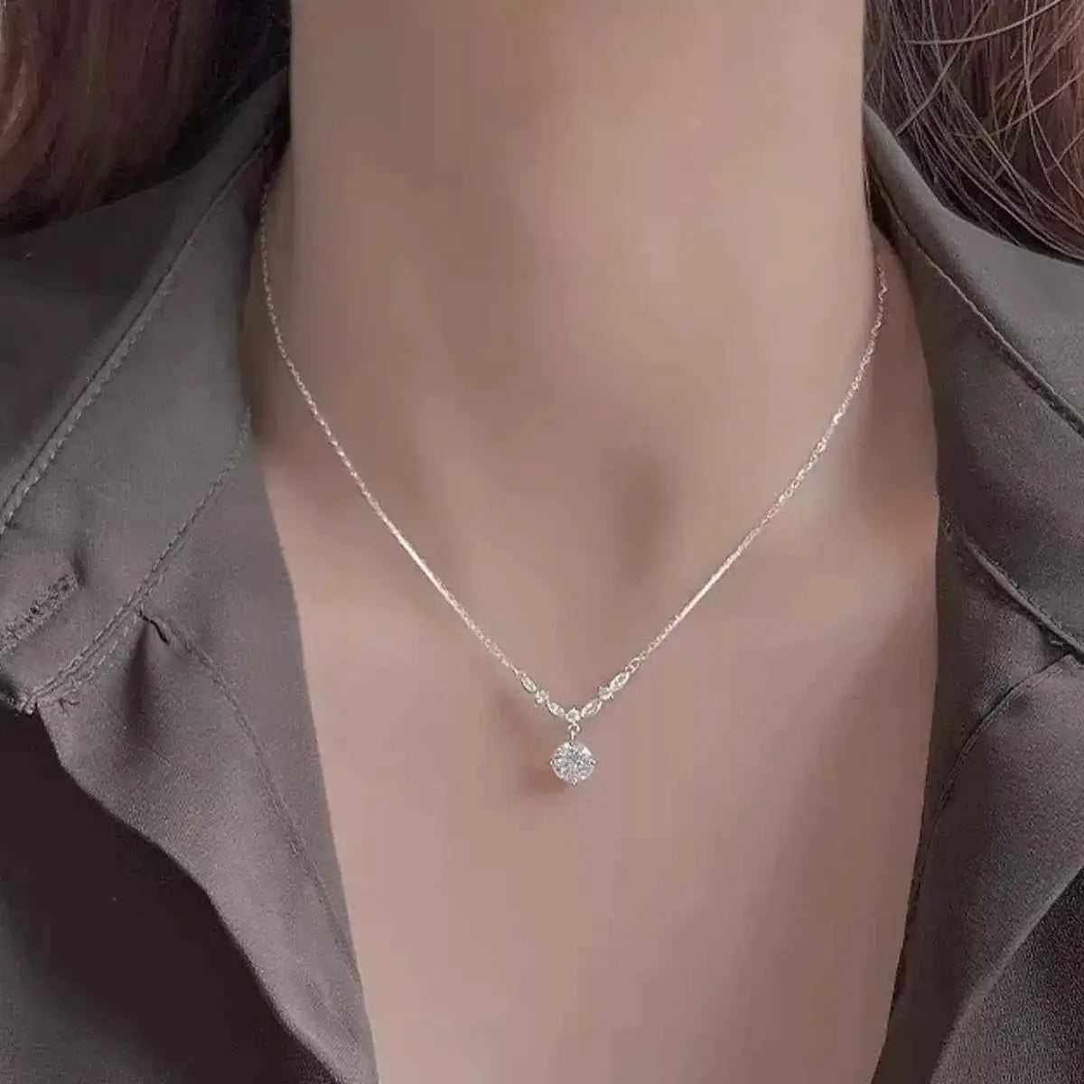 925 Sterling Silver delicate necklace with a small round zircon pendant on a fine chain worn on a woman's neck