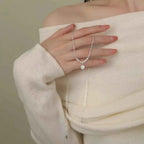 925 Sterling Silver delicate pendant necklace with a small round zircon gemstone, worn on a fine chain by a person