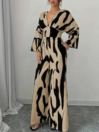 Abstract Print V-Neck beige and black belted wide leg jumpsuit in polyester blend with long sleeves and deep v-neckline